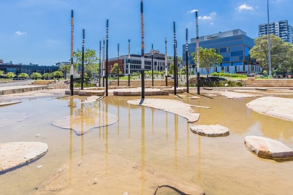 A circular gathering space formed by large timber poles at Leagues Club Park, Gosford.