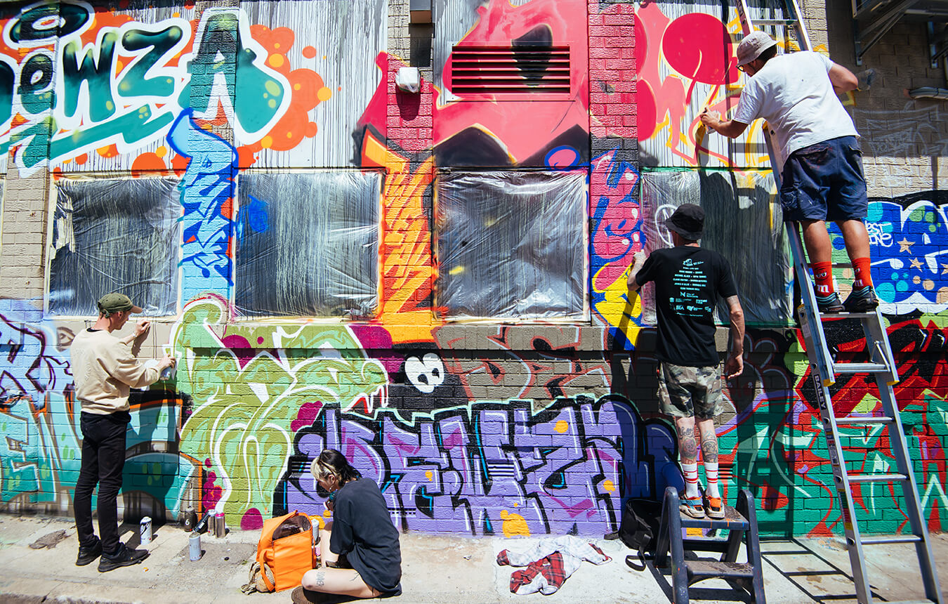 Artists working on the Spray Alley Graffiti Jam in Civic Lane, Newcastle